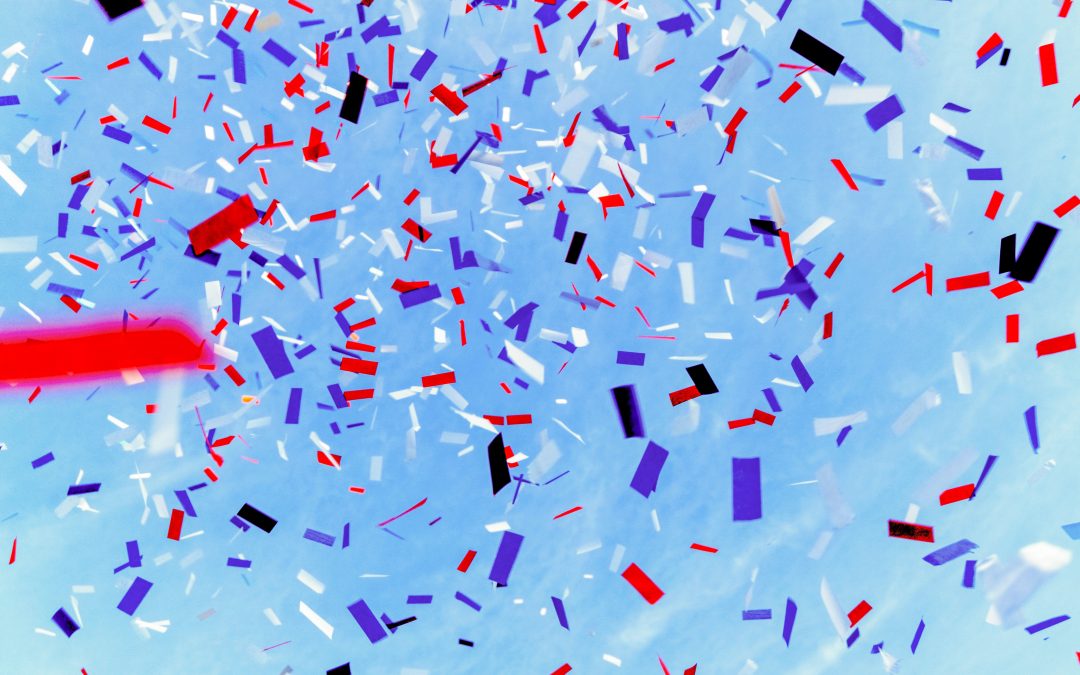 red white and blue confetti with a blue sky background